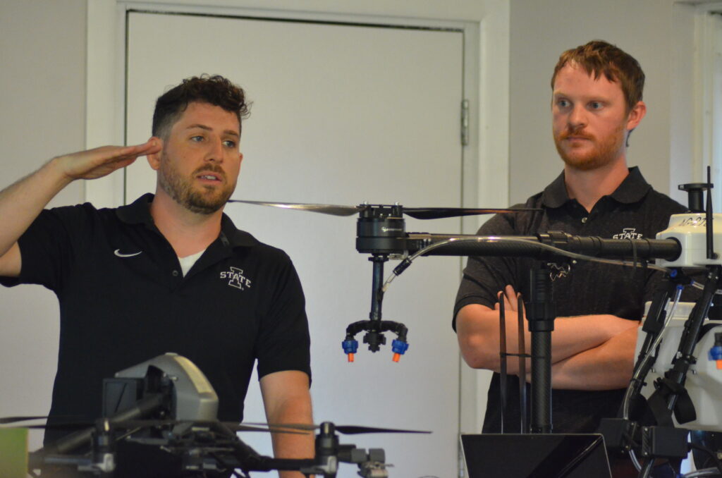Agronomy graduate students Joscif Raigne and Sam Blair talk drones. 