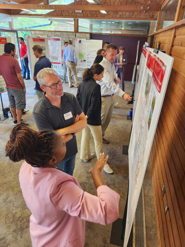 Graduate student Mercy Fakude discusses her research project with Professor Steve Whitham.