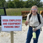 Agronomy student Sabrina Becker finds a parking sign humorous during her internship in Ozark, MO.