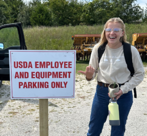 Agronomy student Sabrina Becker finds a parking sign humorous during her internship in Ozark, MO.