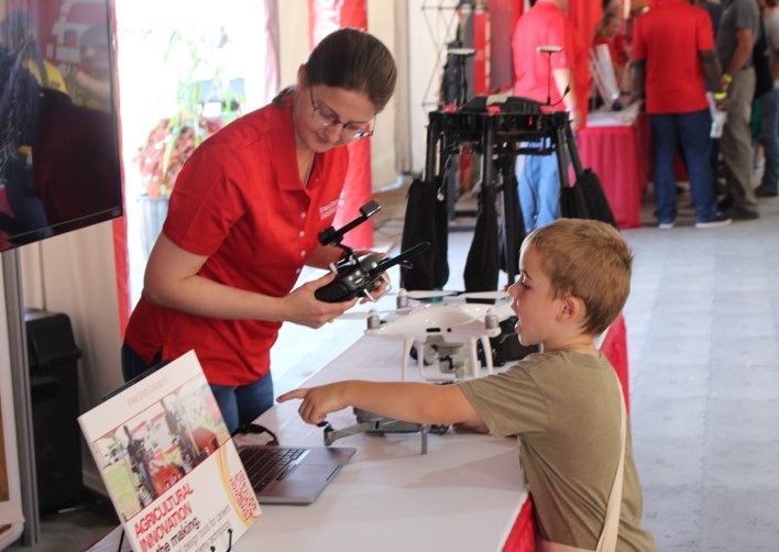 Agronomy graduate student Sarah Jones shared her excitement about drones with a young visitor.